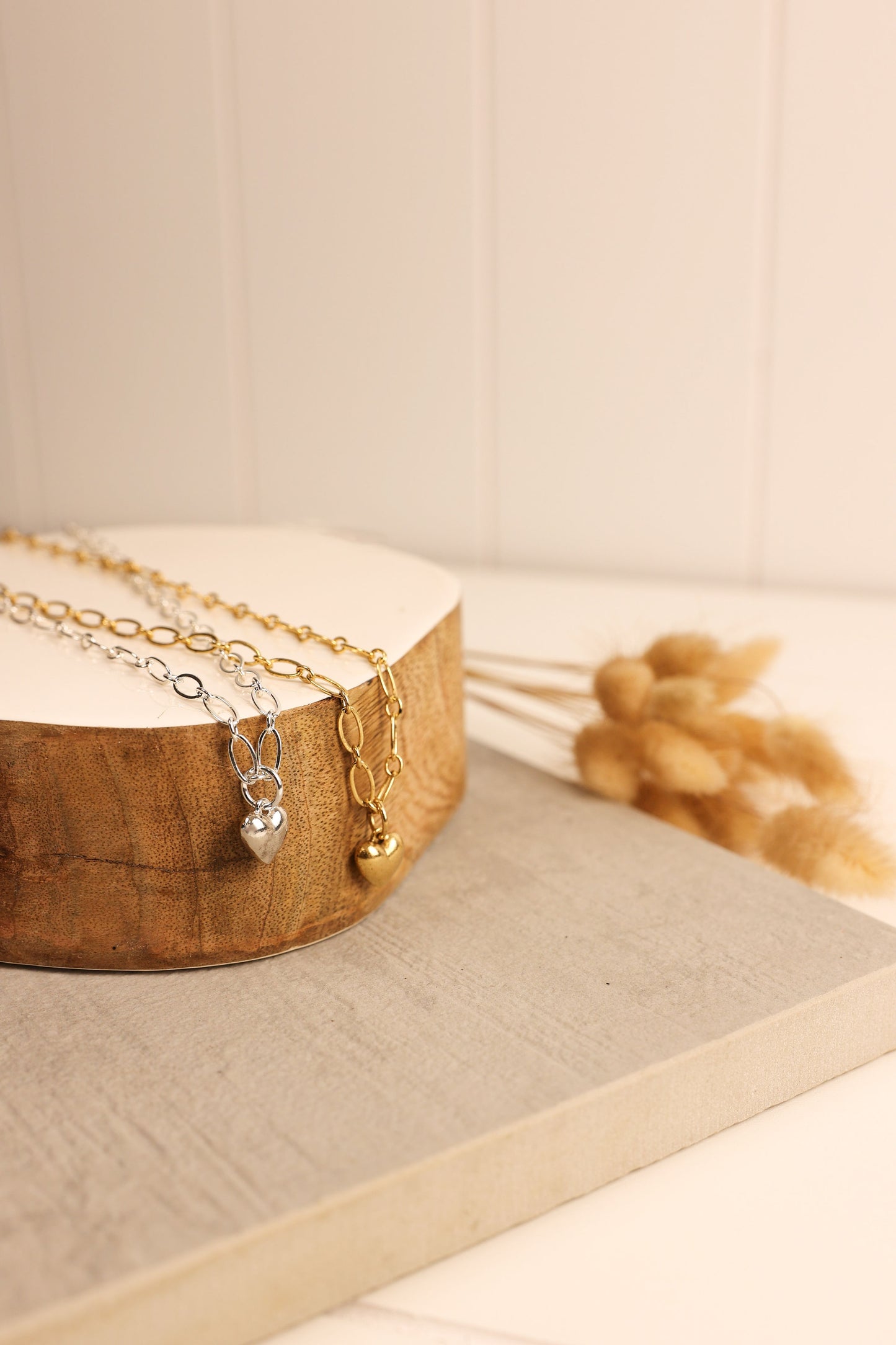 silver and gold heart charm necklace on a chunky chain