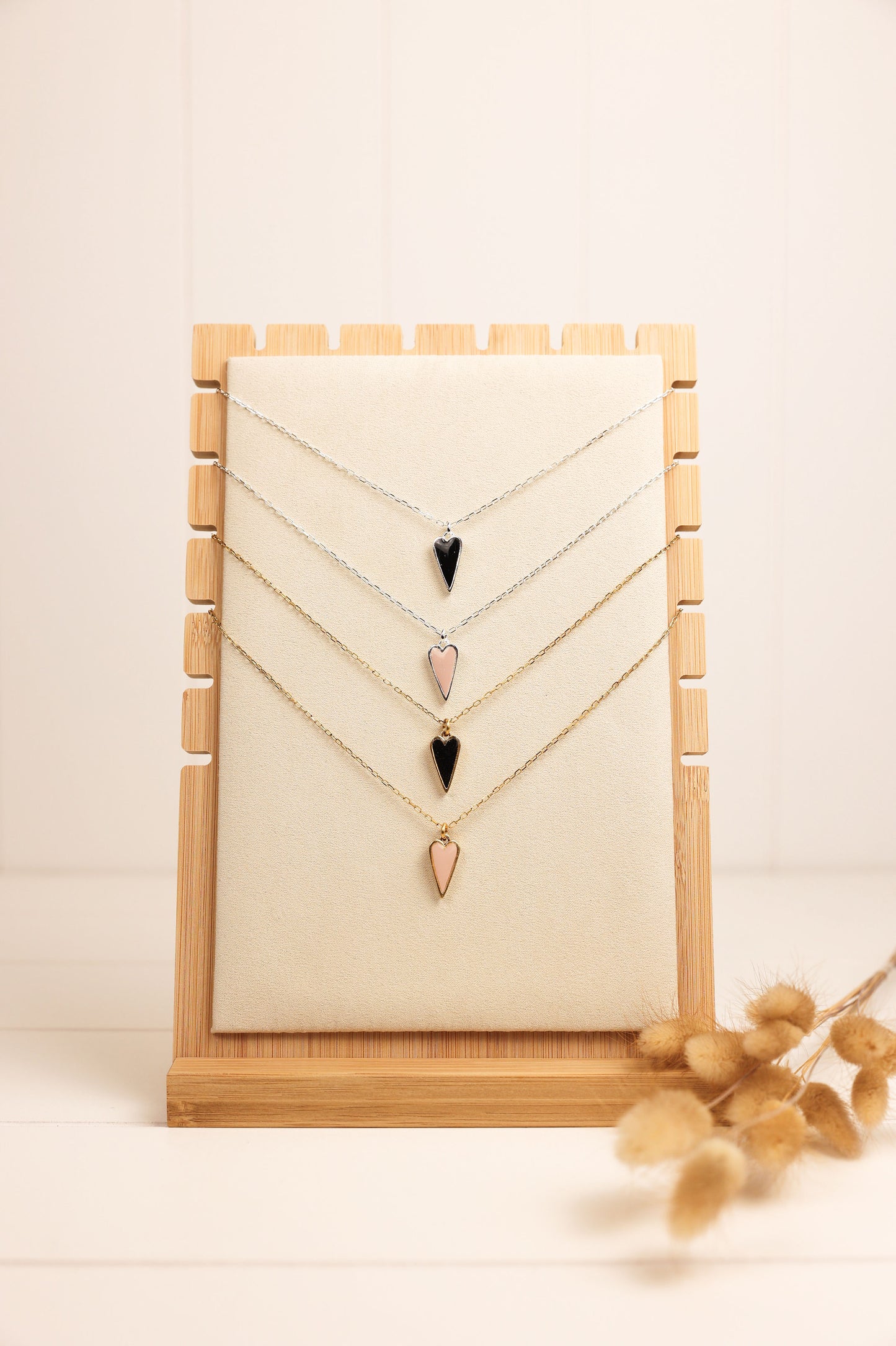 Heart pendent necklace on a delicate chain. Pendant is made of clay pressed into metal. Available in pink or black with a gold or silver chain.