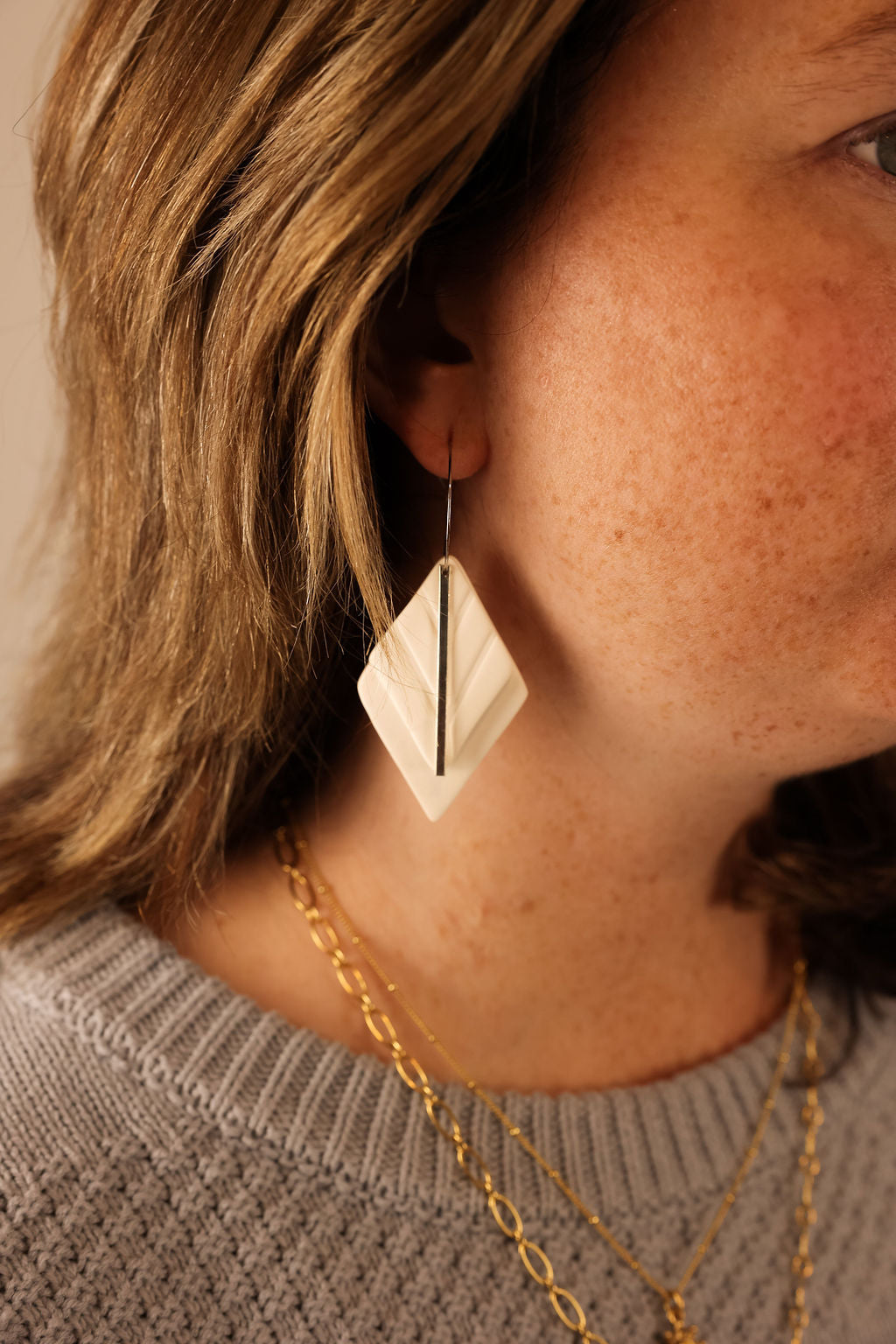 Model wearing Florence earring in white with silver accent