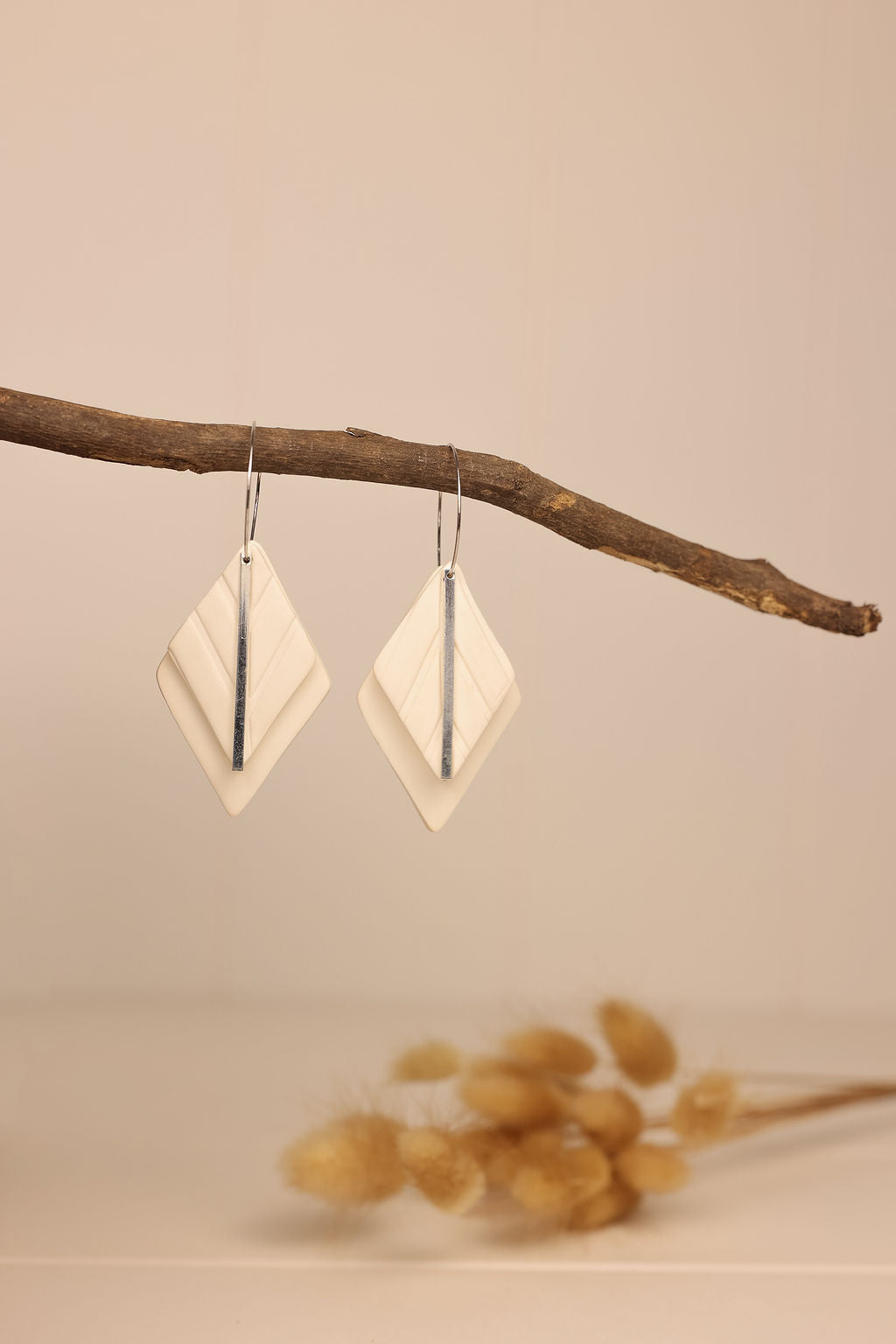 white clay diamond earring with silver accents