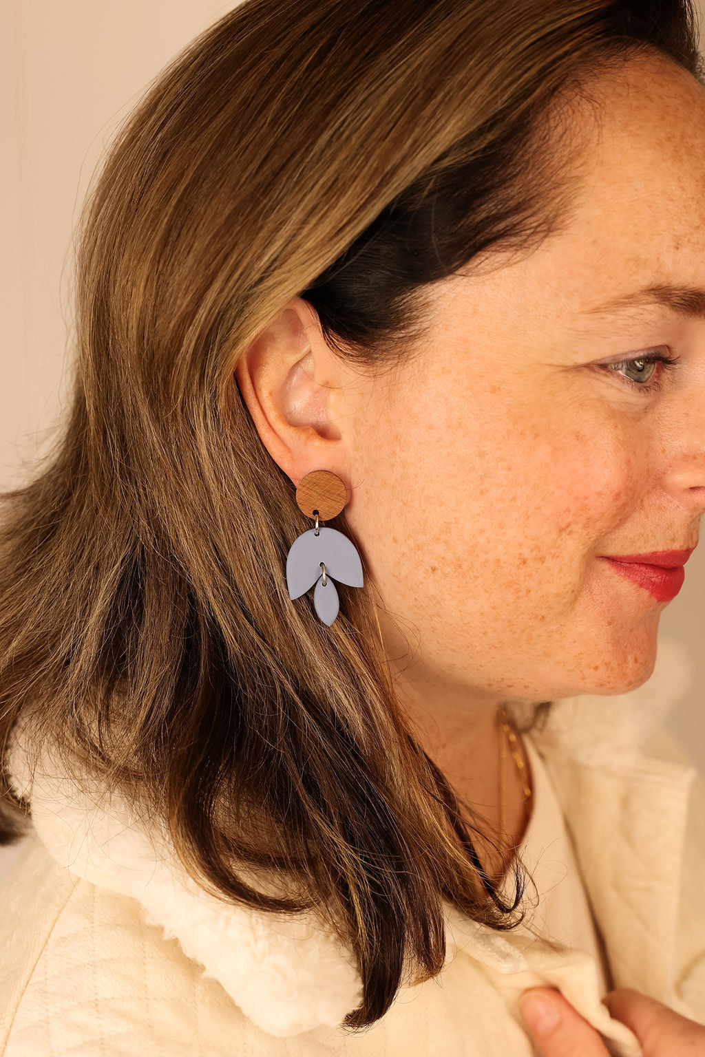Freja earrings in bluestone worn by model.