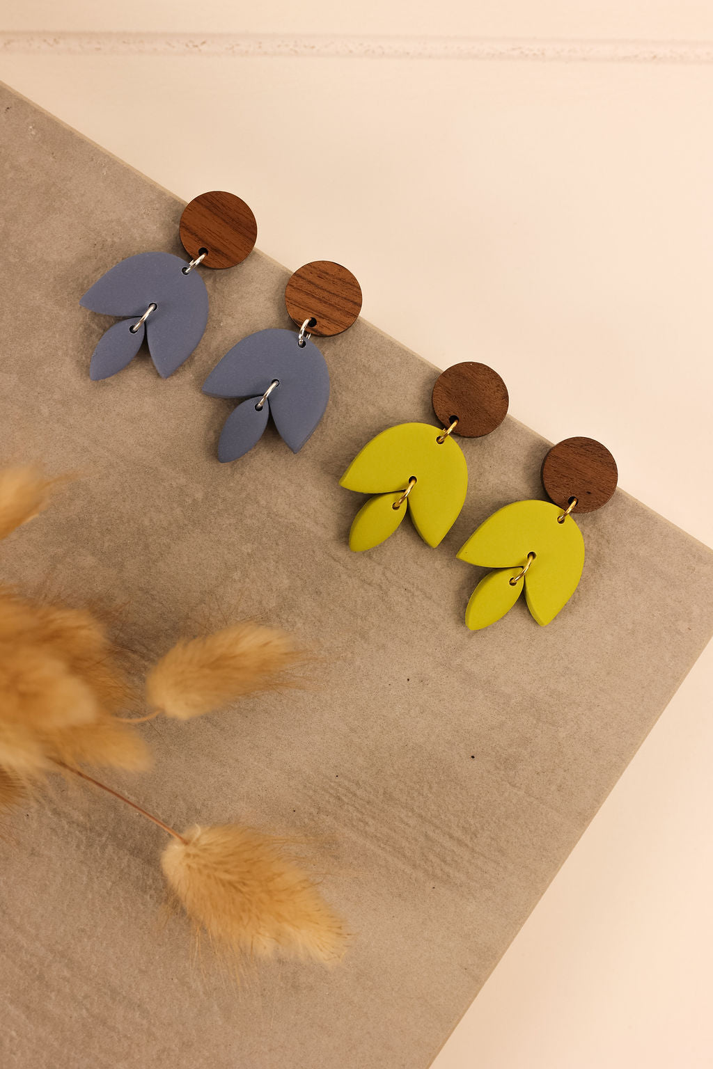 Freja earrings pictures in bluestone and citron on a neutral background.