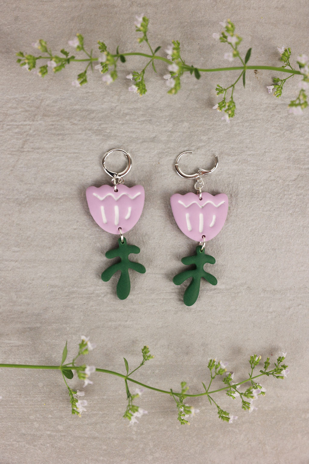 tulip shaped earring with leaf accent in light purple color.