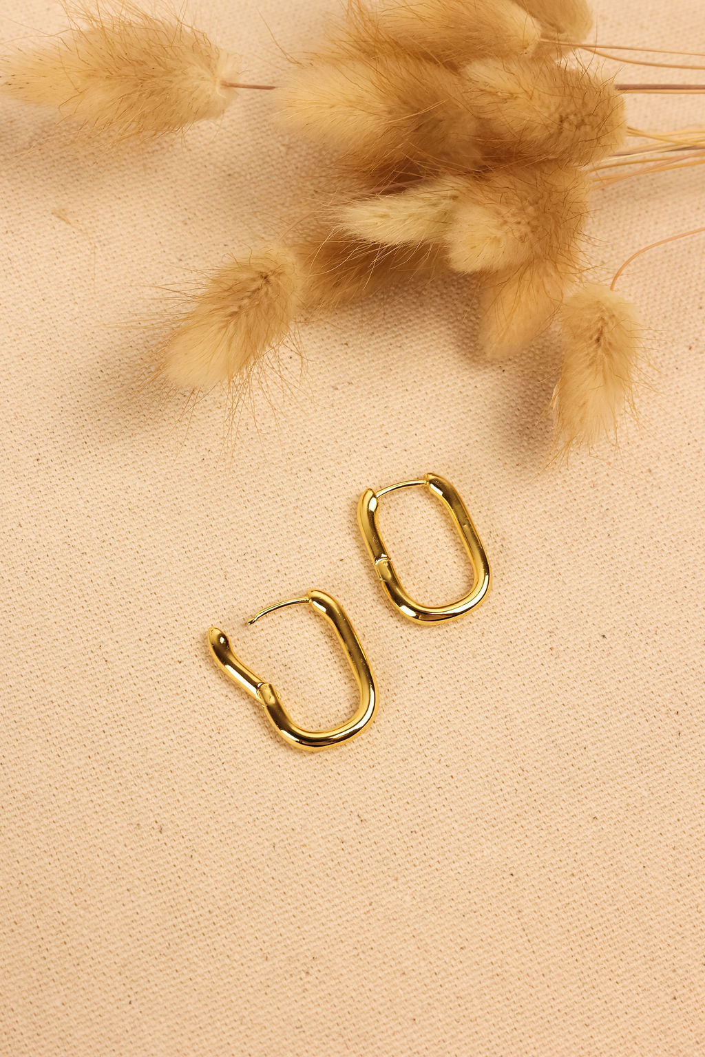 close up of geometric hoop in gold.