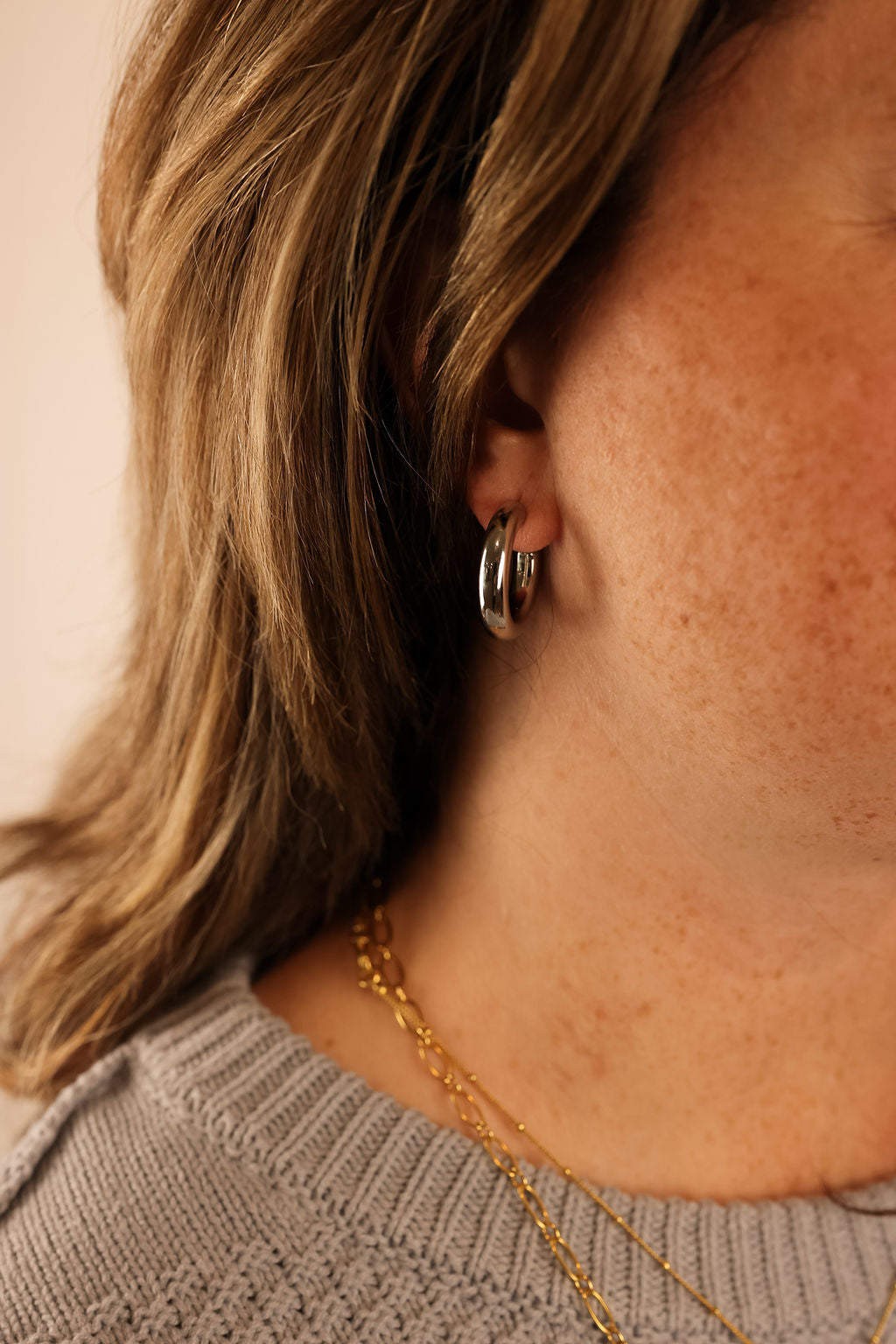 Silver Hollow Hoops being worn by model.