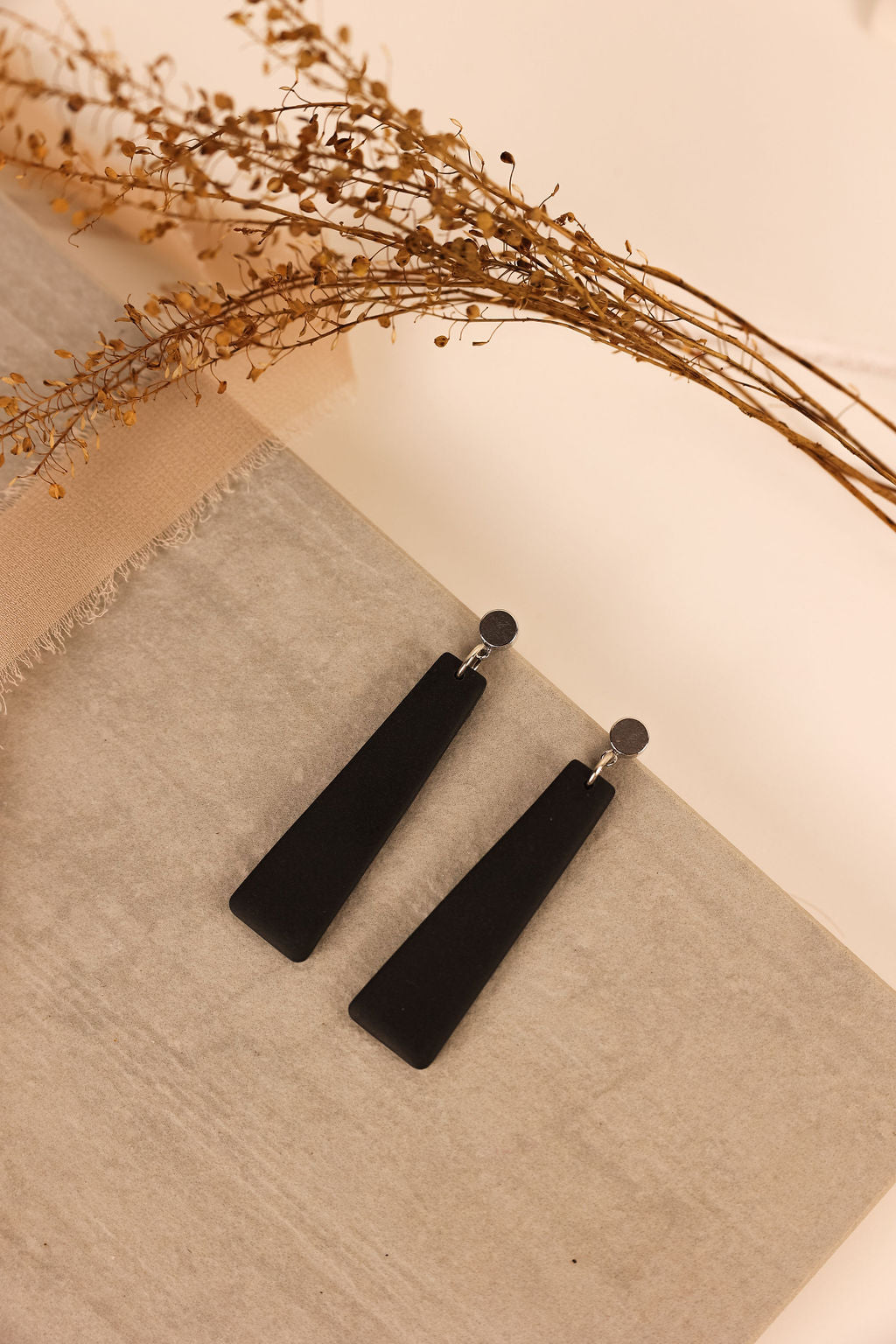 Nora earring with black clay and silver posts.