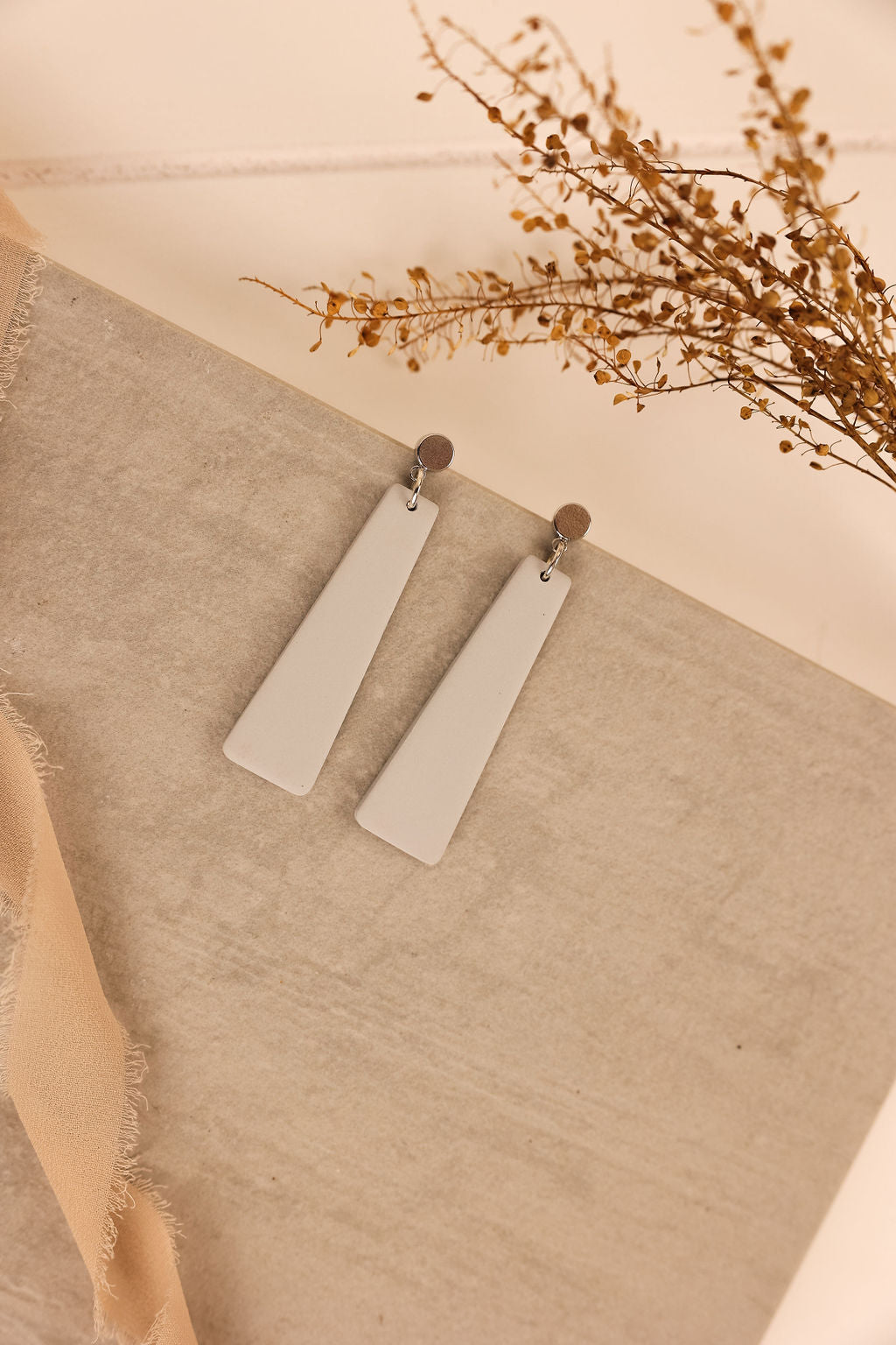 nora earring in grey with silver ear posts.