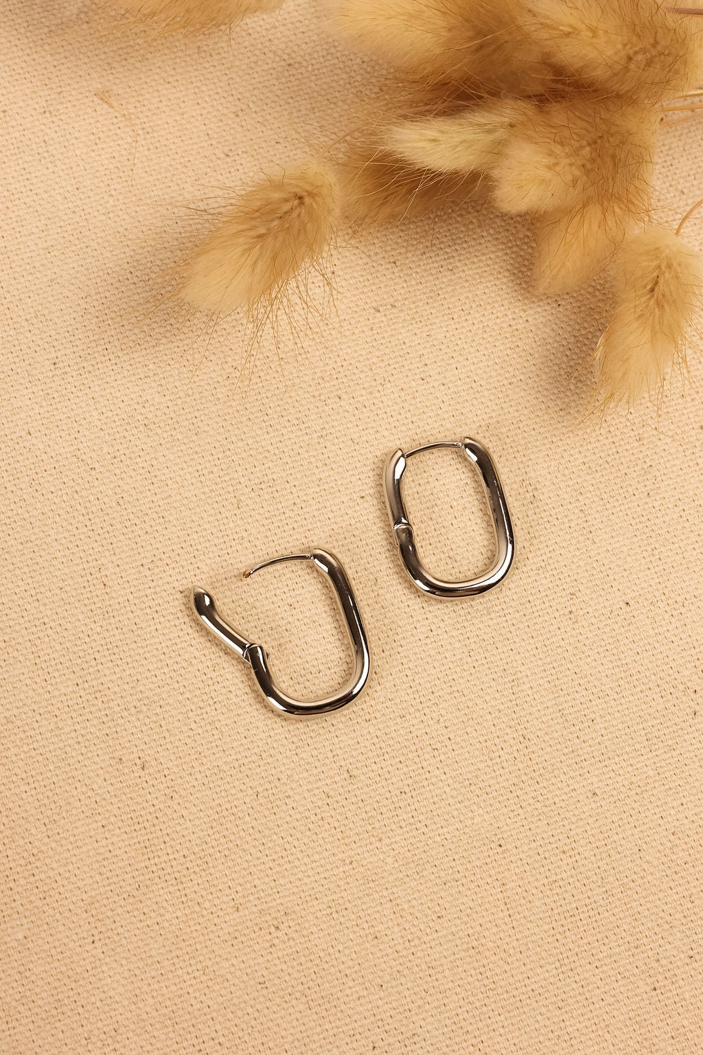 close up image of silver geometric hoops.