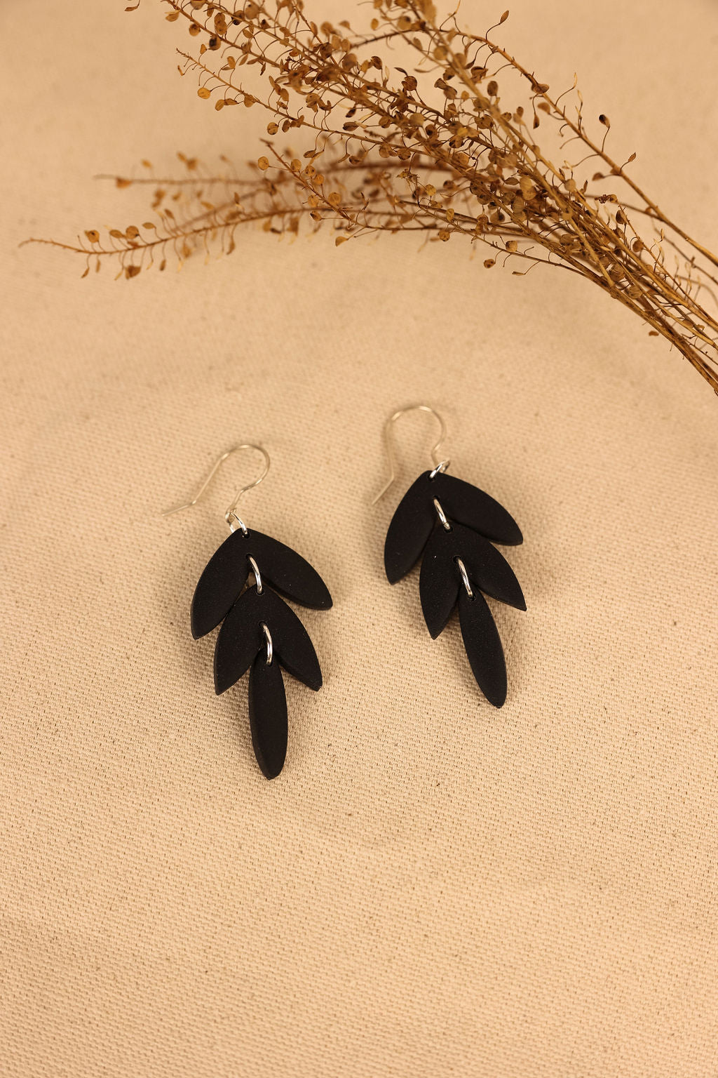 black polymer clay leaf drop earrings.