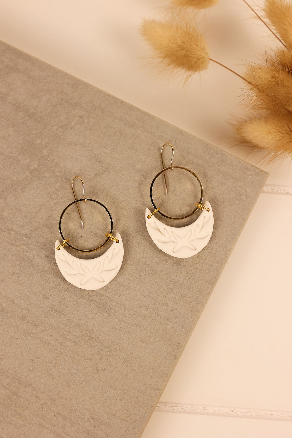 Luna earring in white with gold colored hardware.
