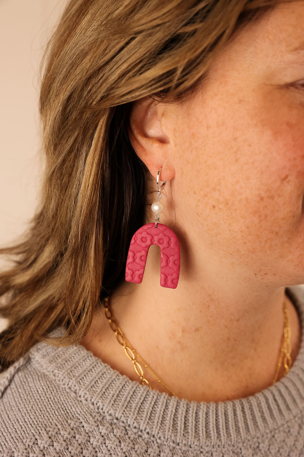 These earrings are handmade from polymer clay. They have a floral arch design and a pearl accent. They are modern, funky and lightweight.