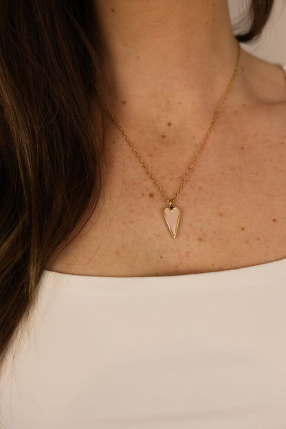 Heart pendent necklace on a delicate chain. Pendant is made of clay pressed into metal. Pink and gold.