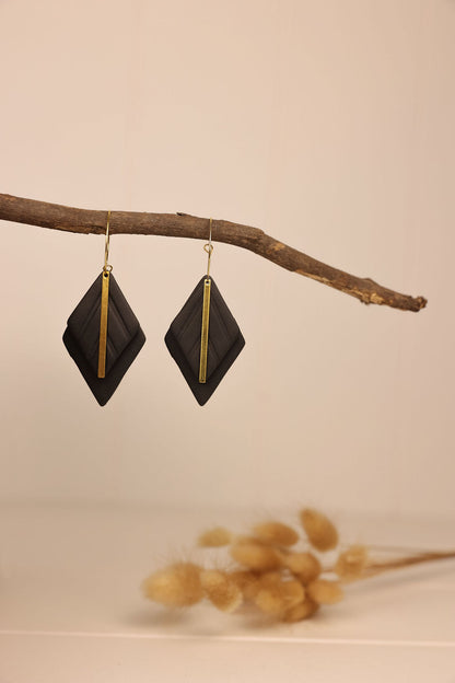 black clay diamond shaped earring with gold accents