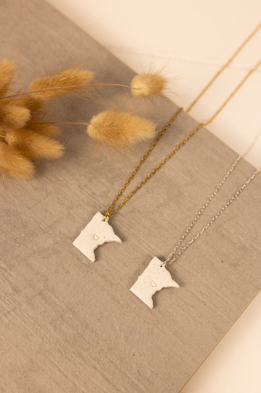 Handmade Minnesota shaped polymer clay necklaces with either gold or silver chain. Each Minnesota pendent has a small heart stamped in the middle. 
