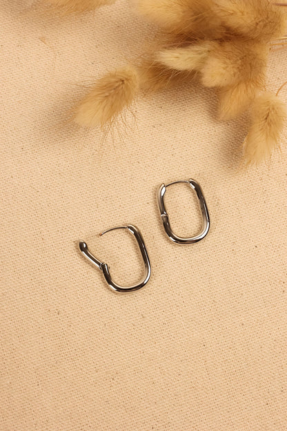 close up image of silver geometric hoops. 