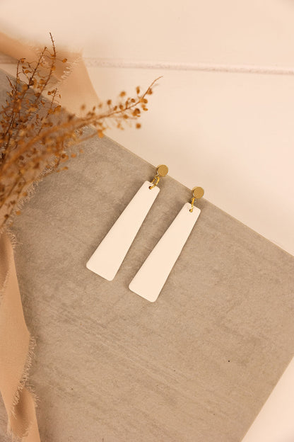 nora earring in white with gold hardware. 
